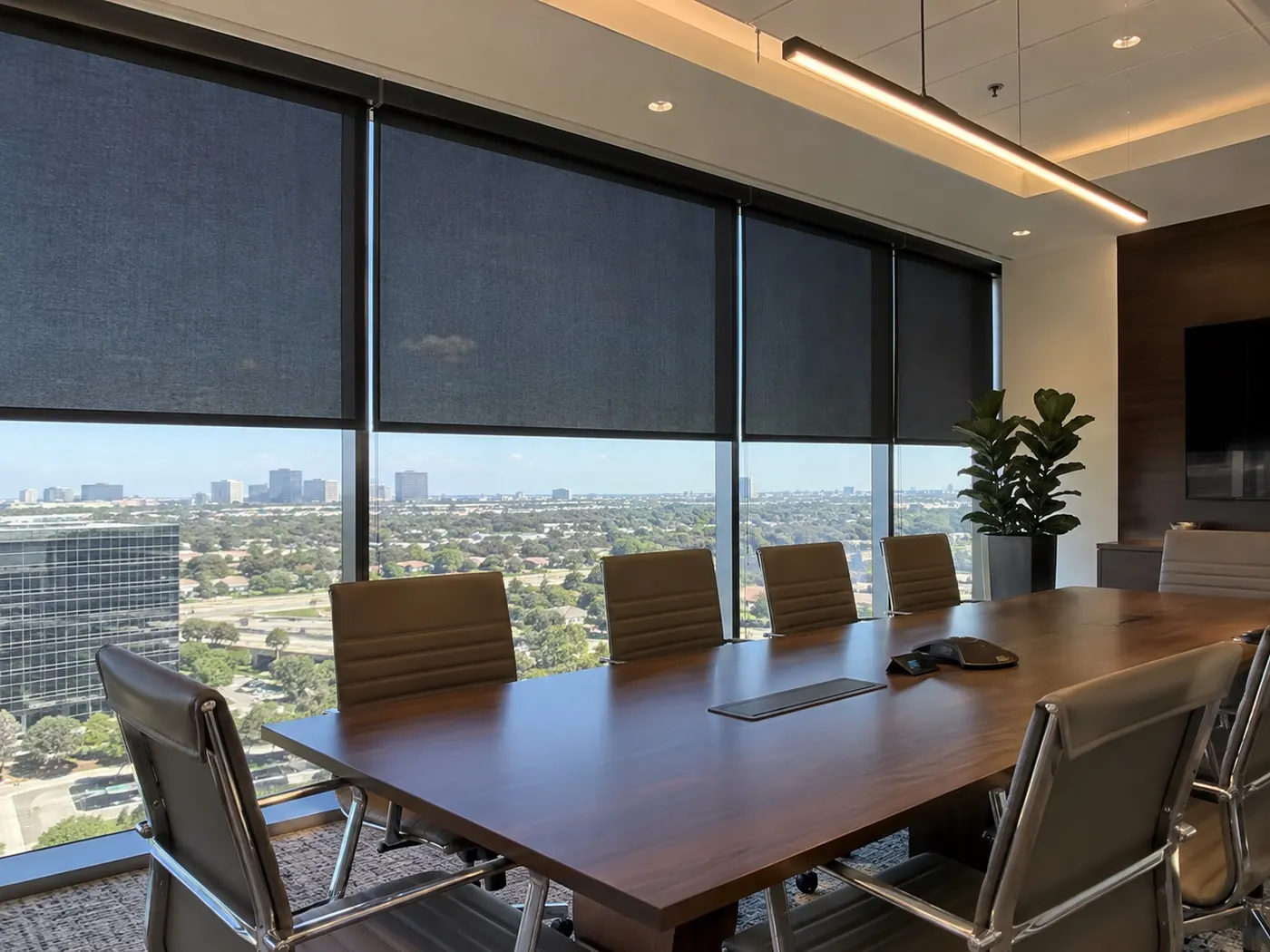 Dark roller shades in a high-rise conference room