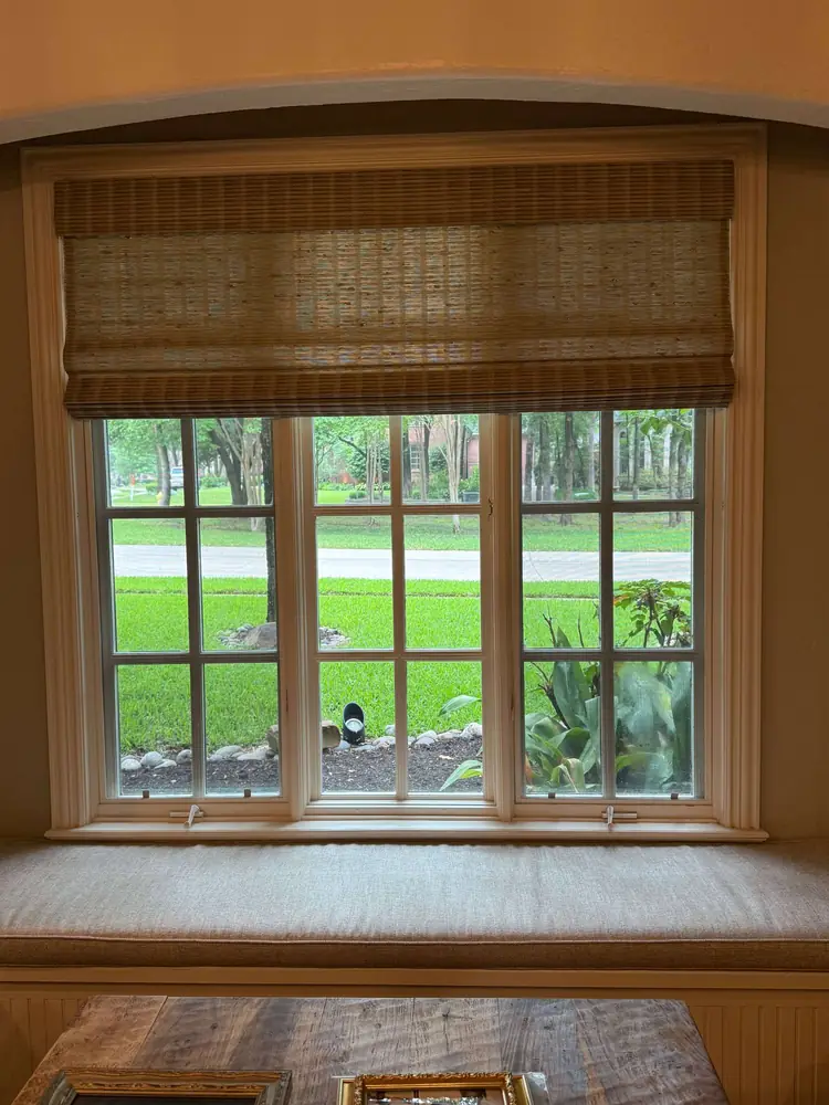 Woven Roman shade over a window seat