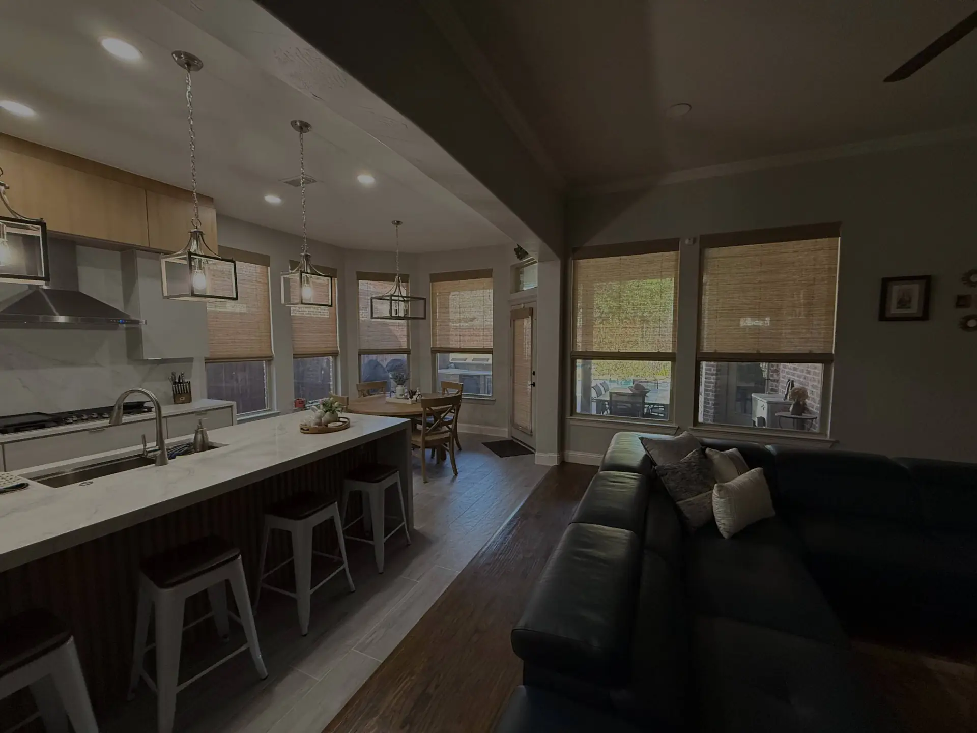 Kitchen and living room with custom shades installed by AWC Texas