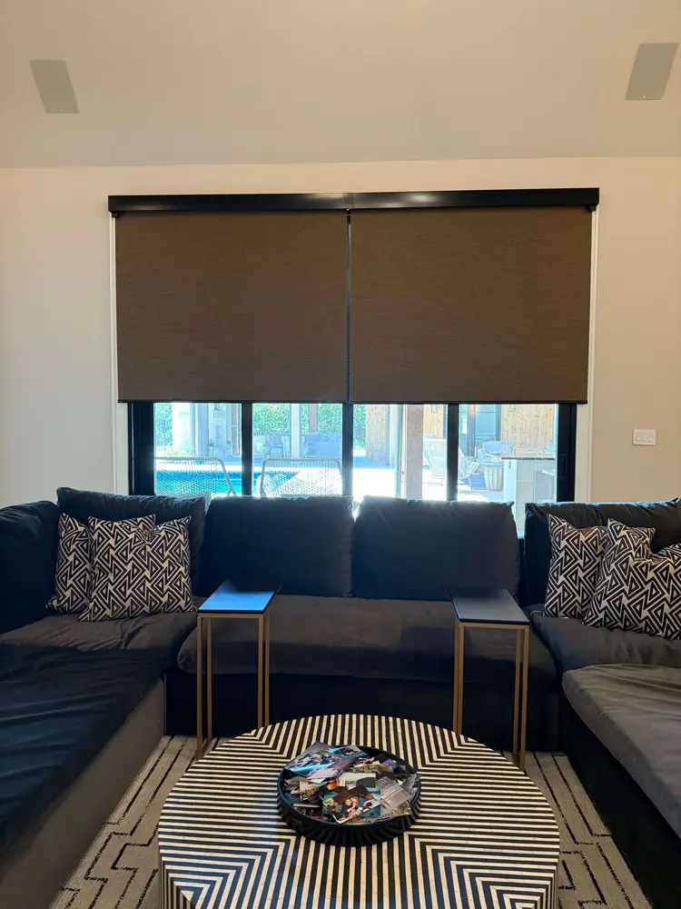 Room-darkening roller shade in a living room