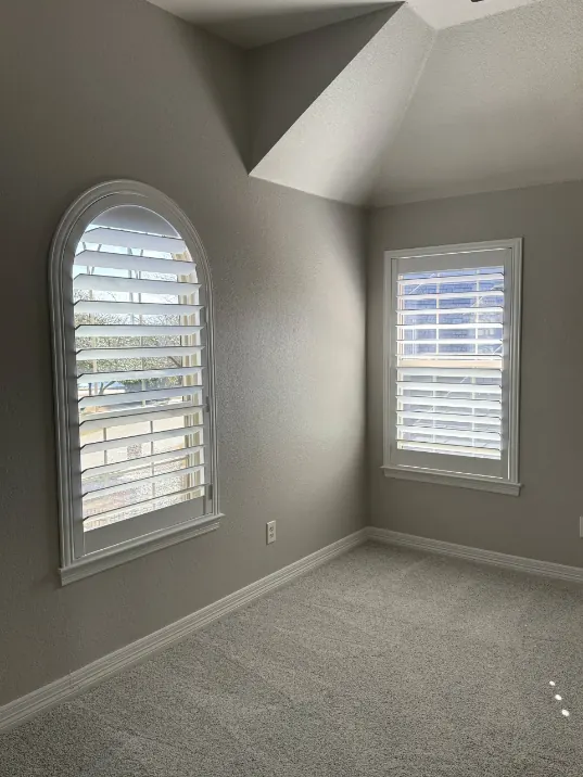 Plantation shutters on an arched window